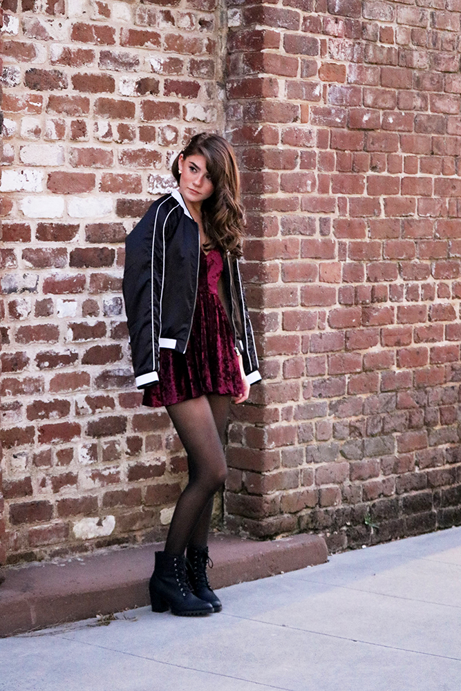 Pair a satin bomber jacket with a velvet romper for a fun contrast!