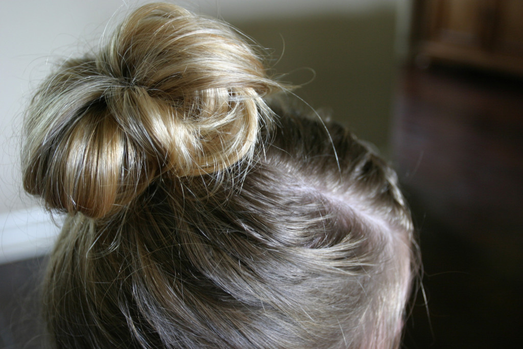 View from the back of a highlighted blonde messy bun.