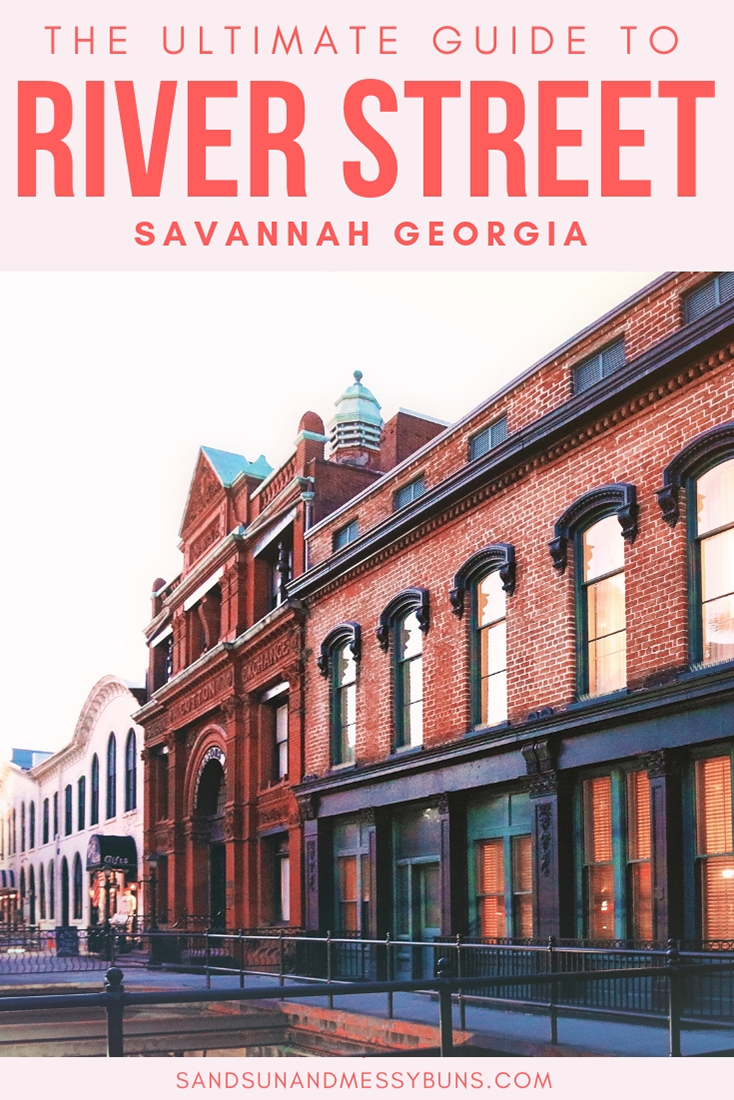 Along River Street in Savannah GA a pink-hued sunset reflects in the windows of a row of old brick buildings.