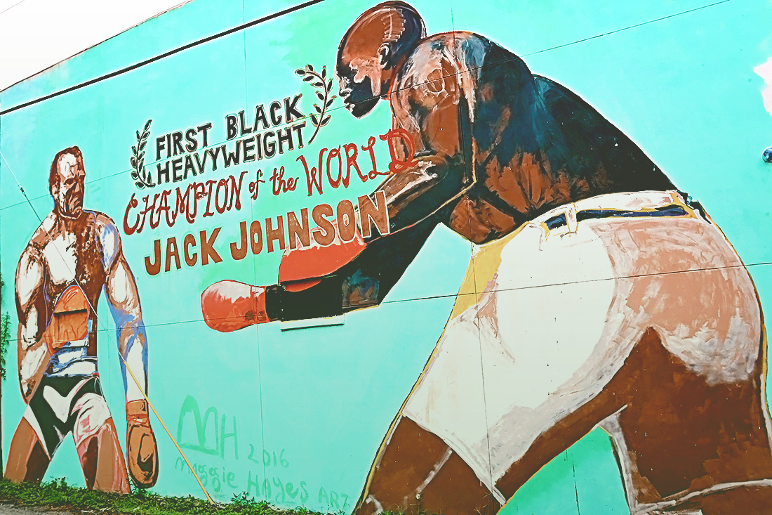 Two-story wall painted with Jack Johnson The First Black Heavyweight Champion of the World sparring with another man.