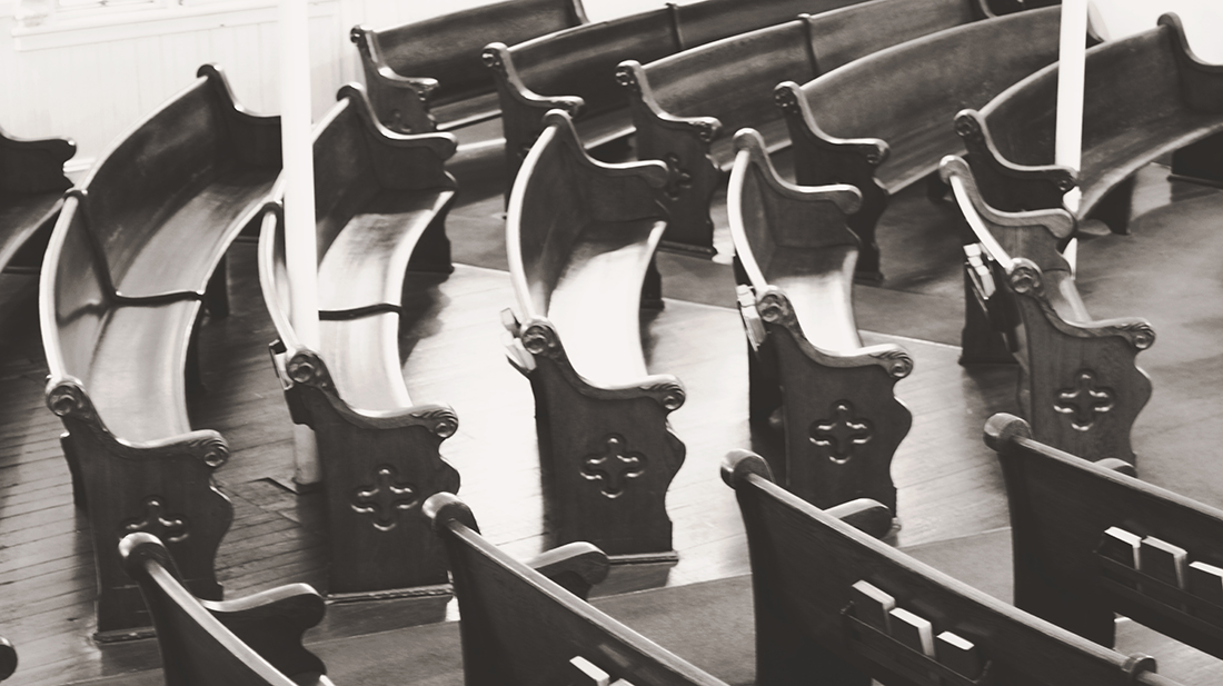 Curved arrangement of church pews shown in black and white