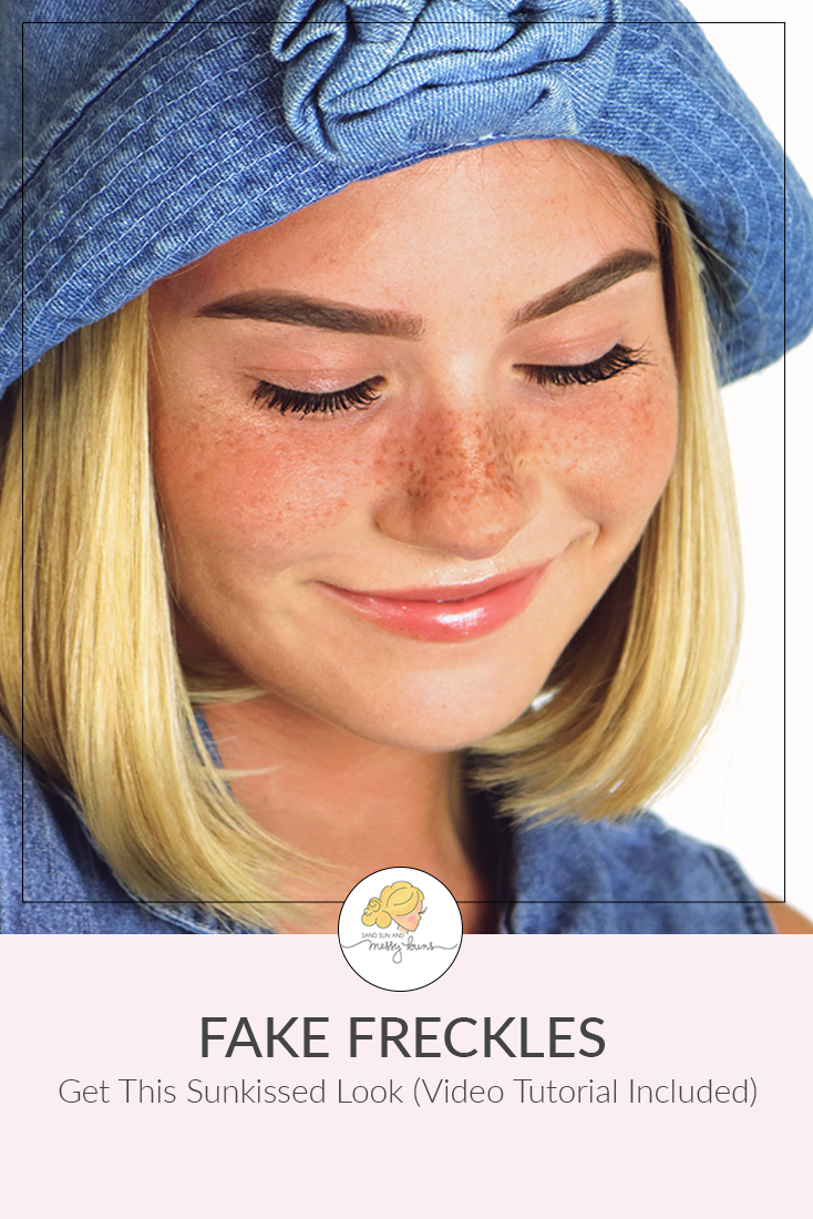 Teen girl with shoulder length blonde hair and a happy smile with a scattering of fake freckles across her nose.