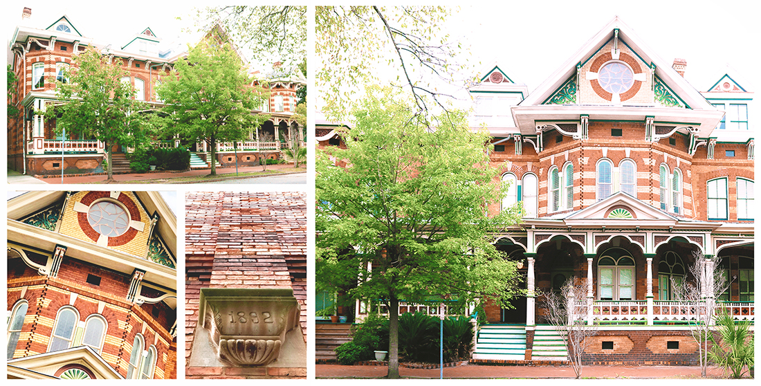 Multi-family 3-story brick Victorian with green, orange, and yellow trim.
