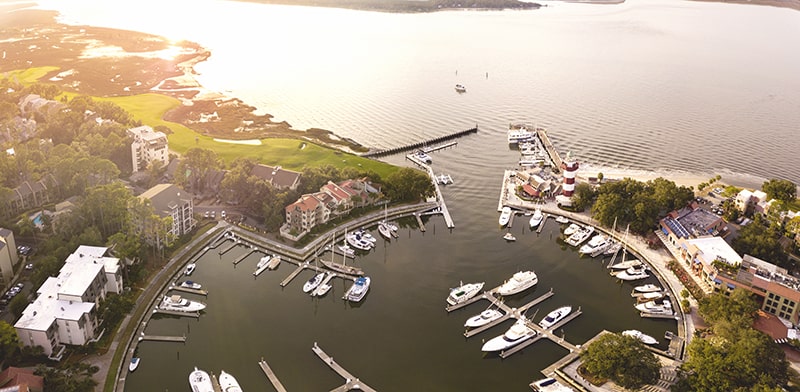 An aerial view of Harbour Town Marina as the sun sets over the creek.