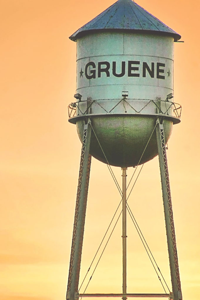 The famous Gruene water tower with an orange sunset in the background.